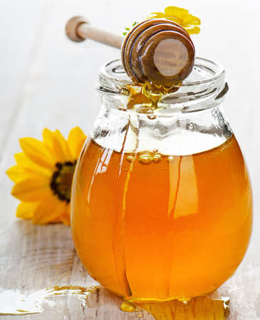 Jar of honey with wooden stick.Selective focusの写真素材