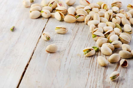 Pistachios on wooden table. Selective focus
