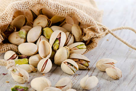 Pistachios on wooden table. Selective focusの写真素材