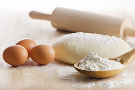 Dough with eggs  on wooden table. Selective focusの写真素材