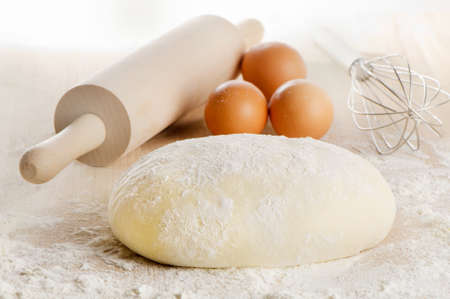 Dough with eggs  on wooden table. Selective focusの写真素材