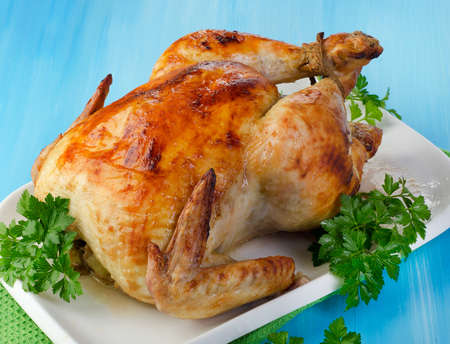 Roasted chicken with fresh herbs. Selective focusの写真素材