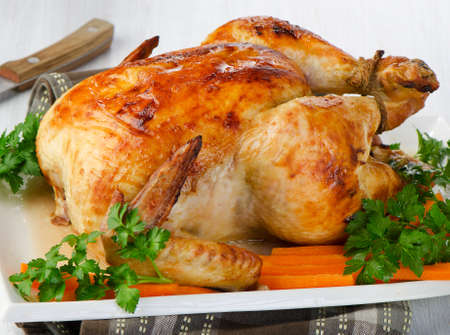 Roasted chicken with fresh herbs. Selective focusの写真素材