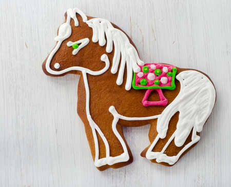 Gingerbread horse on wooden tableの写真素材