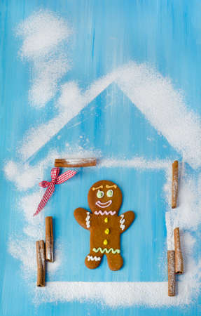 Gingerbread man in house on wooden tableの写真素材