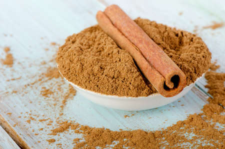 Cinnamon sticks and powder . Selective focus