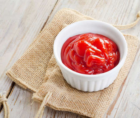 Tomato sauce  on a wooden table