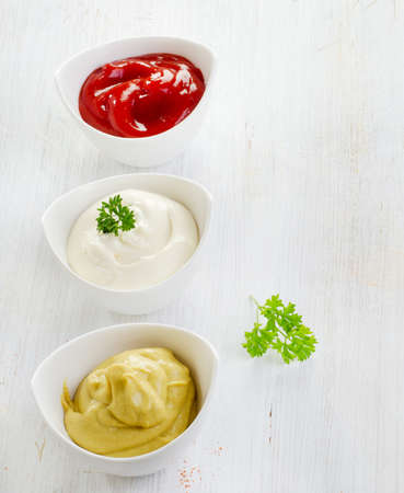 Mustard, ketchup and mayonnaise   on wooden table .Selective focusの写真素材