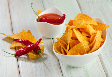 Corn chips  with sauce on wooden tableの写真素材