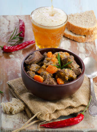Bowl of beef stew and beerの写真素材