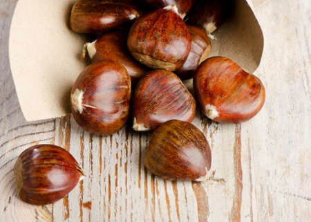 chestnuts on wooden tableの写真素材