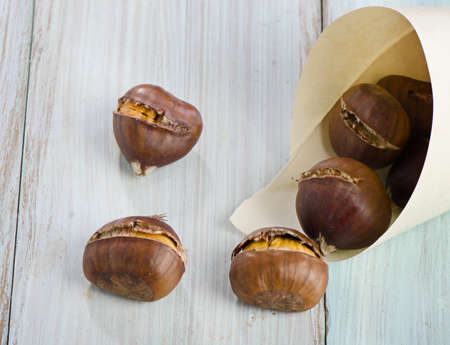 chestnuts on a wooden tableの写真素材