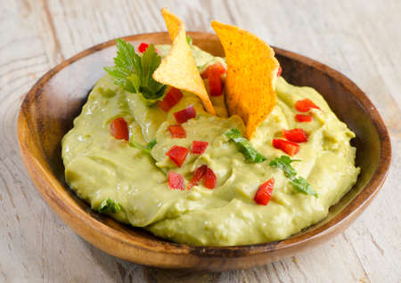 Guacamole on wooden tableの写真素材