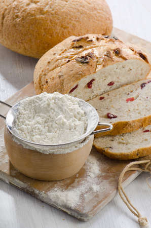 Bread and flour on wooden tableの写真素材