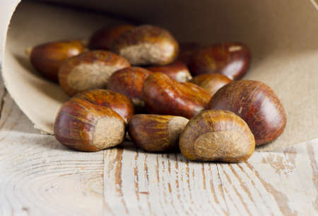 chestnuts on wooden tableの写真素材