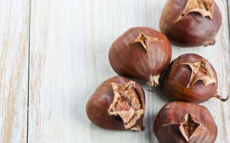 chestnuts on a wooden tableの写真素材
