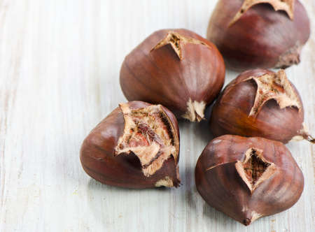 chestnuts on a wooden tableの写真素材