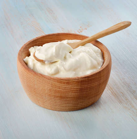 Fresh yogurt in wooden bowl  Selective focusの写真素材