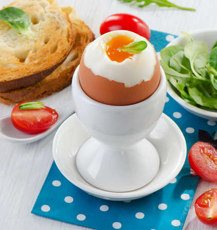 Soft boiled egg with toast and herb - healthy breakfast. Selective focusの写真素材