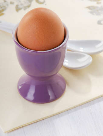 Boiled brown egg in eggcup. Selective focusの写真素材