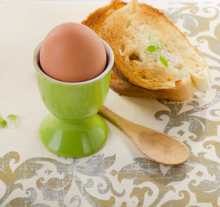 Boiled brown egg in eggcup. Selective focusの写真素材