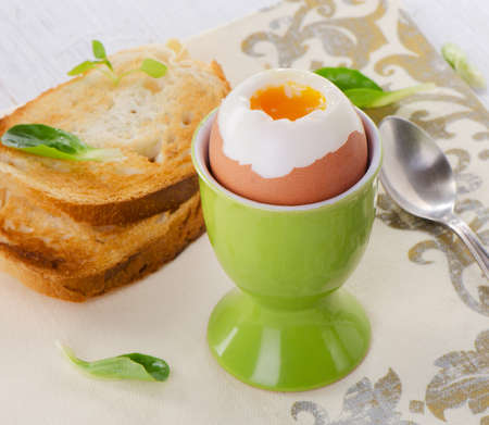 Soft boiled egg with toast and herb - healthy breakfast. Selective focusの写真素材