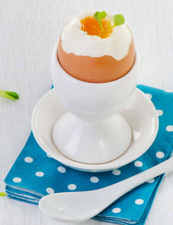 Soft boiled brown egg in eggcup. Selective focusの写真素材