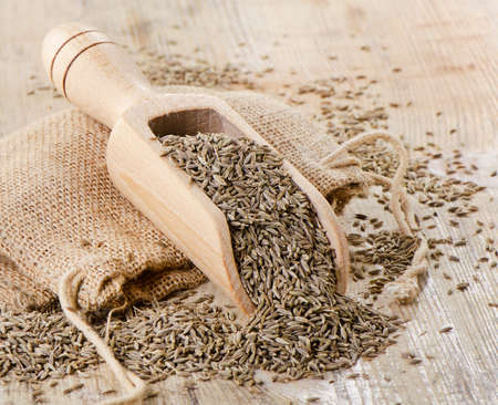 Cumin seeds in wooden scoop. Selective focusの写真素材