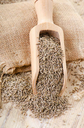 Cumin seeds in wooden scoop. Selective focusの写真素材