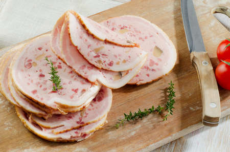 Slices of mortadella on wooden plate. Selective focusの写真素材