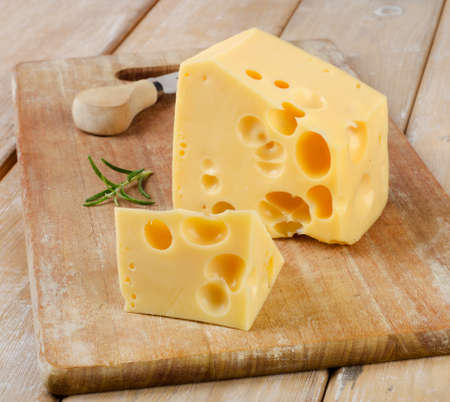 piece of  Cheese on a wooden table. Selective focus