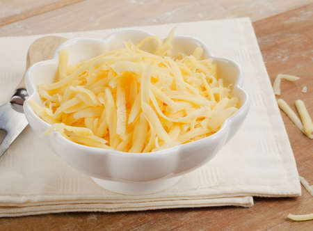 Grated Cheese on a wooden table. Selective focus