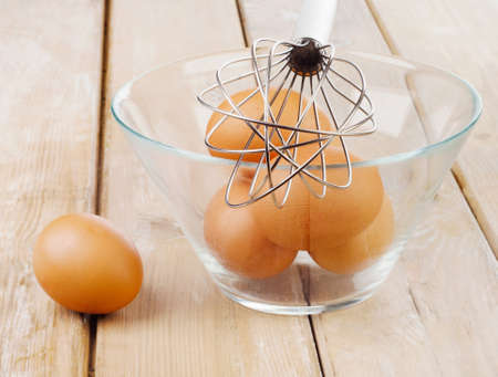 Fresh brown eggs in glass bowl. Selective focusの写真素材