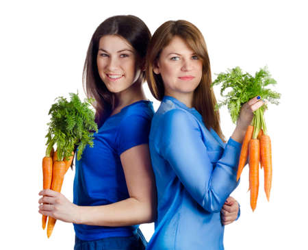 Young smiling women holds bunch of carrots isolated on whiteの写真素材