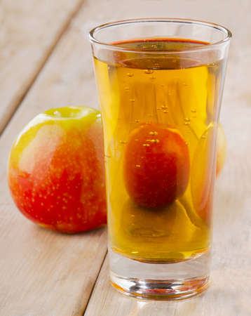 Apple juice and apples on wooden table. Selective focusの写真素材
