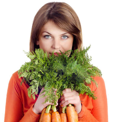 Young smiling woman with carrots isolated on white bakgroundの写真素材