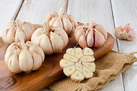 Garlic on a wooden platter. Selective focusの写真素材
