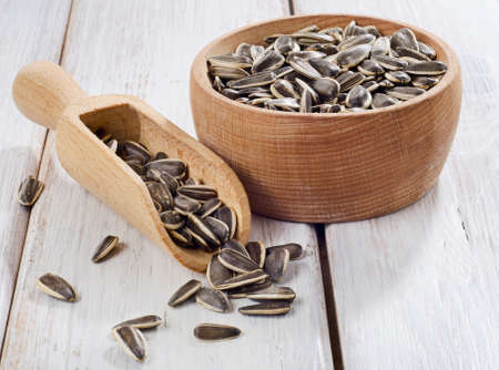 Raw Sunflower seeds in a wooden bowl . Selective focusの写真素材