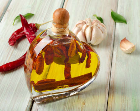 Bottle of olive oil on wooden table. Selective focusの写真素材