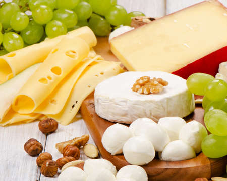 Cheese with fruits and nuts on a wooden table. Selective focusの写真素材