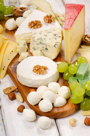 Cheese with fruits and nuts on a wooden table. Selective focusの写真素材