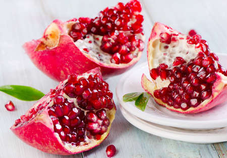 Pomegranates on a white plate. Selective focusの写真素材