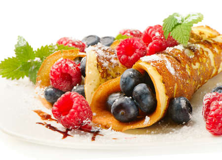 pancakes with raspberries and blueberies isolated on white. Selective focusの写真素材