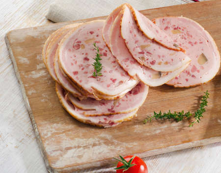 Slices of mortadella on wooden platter. Selective focusの写真素材