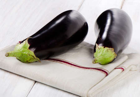 Two eggplants  on a wooden table. Selective focusの写真素材