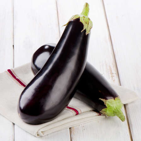 Two eggplants  on a wooden table. Selective focusの写真素材