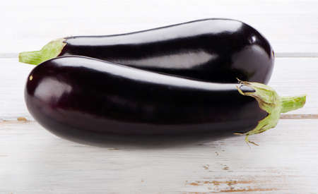 Two eggplants  on a wooden table. Selective focusの写真素材