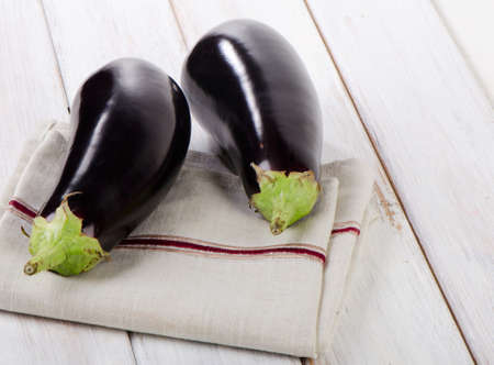 Two eggplants  on a wooden table. Selective focusの写真素材