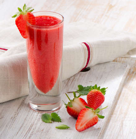 Strawberry smoothie with fresh berries on a wooden table . Selective focusの写真素材
