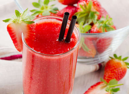 Strawberry smoothie with fresh berries on a wooden table . Selective focusの写真素材